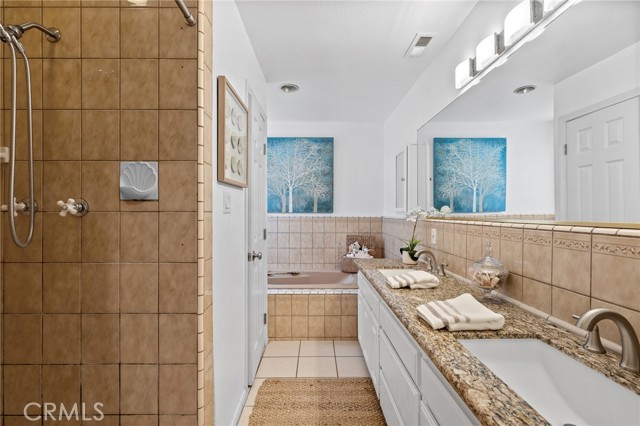 Private en-suite spa bath with step-in shower and separate jetted tub + private water closet