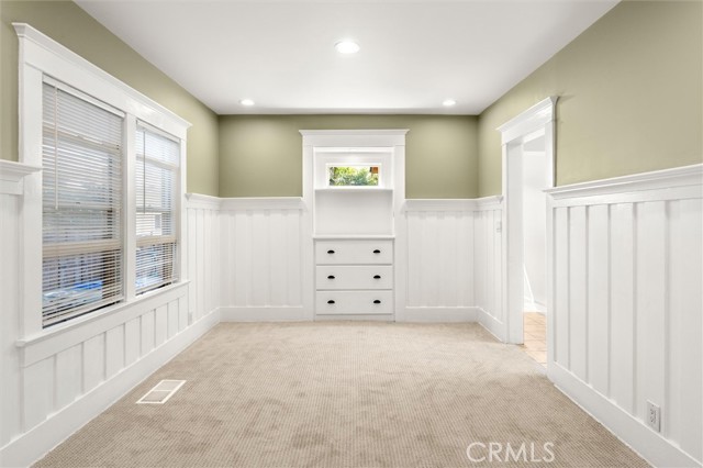Exquisite finishes with attention to detail include hand crafted built-ins and wainscoting in the dining room.