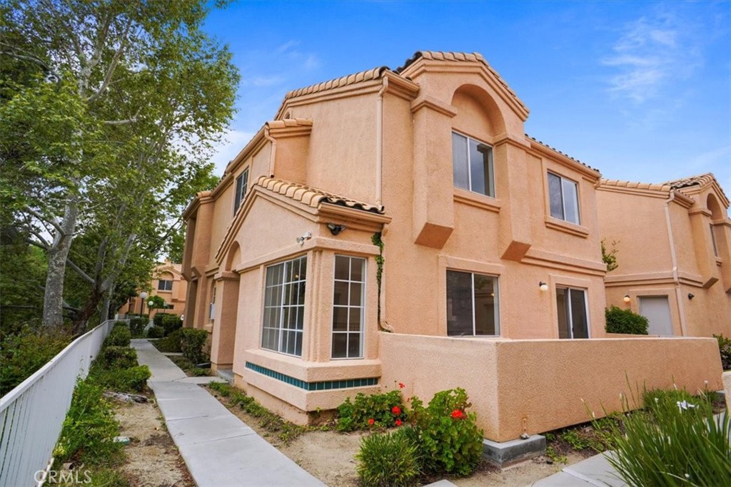Excellent location in the desirable gated community of Vista Del Canon. This two story townhouse offers 3 bedrooms and 2.5 baths with approximately 1,176 square feet of living space with a functional, flowing floor plan.  This is a end unit with many windows which provide natural light and views of the surrounding trees and mountains.  The living area features tile floors, a charming fireplace and a sliding door to your own private patio.  There is a good-sized kitchen with ample storage, pantry, and breakfast bar.  Upstairs you will find a primary bedroom with a private. full bathroom,  two additional bedrooms, a full hall bathroom and convenient upstairs laundry. Other features include: 2-car garage, central air and heat, washer, dryer, & refrigerator.  The HOA provides pool, spa, water, and trash.  Easy freeway access and conveniently located near shopping and restaurants.