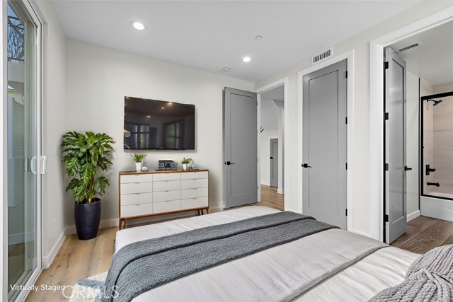 Bedroom 2 on the lower level with door to back patio virtually staged
