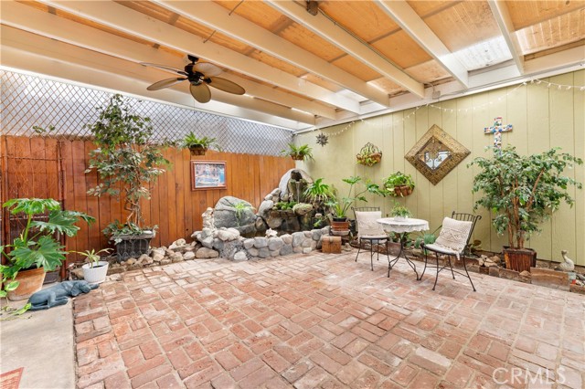 Private Patio w/ ceiling fans, waterfall & fish pond