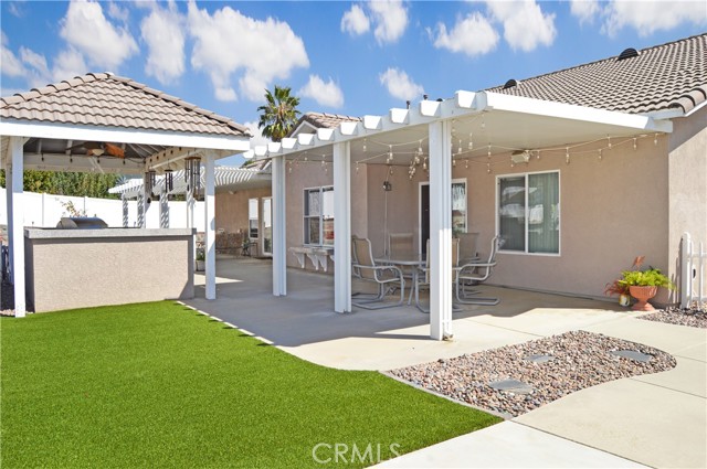 Covered BBQ/Outdoor Kitchen Next to BRAND NEW Pet-Friendly Artificial Grass Area and Covered Dining Patio