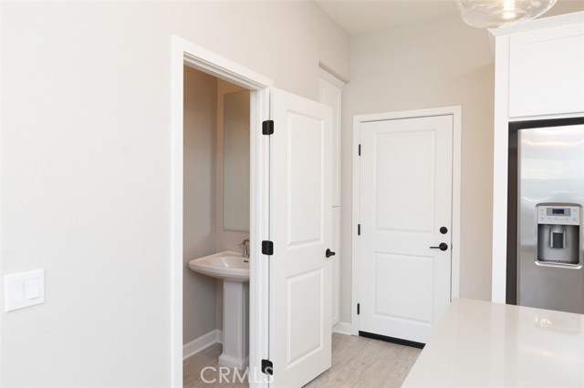View of powder room from kitchen
