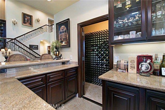 The walk behind wet bar is next to  a collector’s wine cellar for those who enjoy to collect their favorite label.