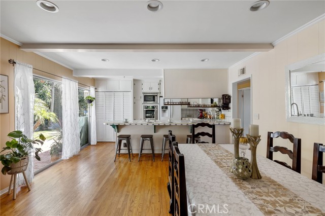 Family room/dining room - you decide.  This flexible room has smooth ceilings with recessed lights and beams. Adjacent to open kitchen.  If the living room is the hub of the house - this is the heart.