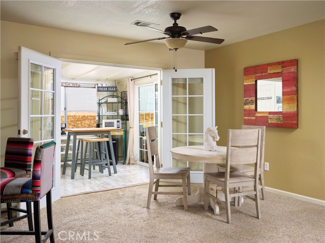 French doors open to enclosed porch and entry to Air BnB. Dining area adjacent to living room