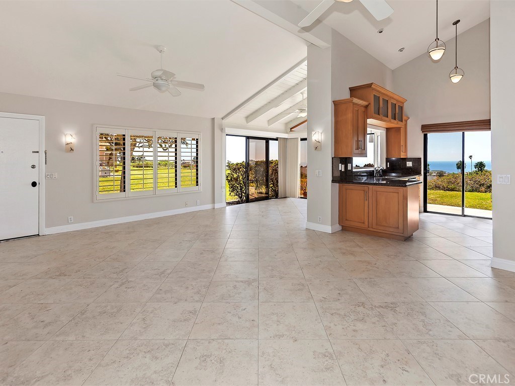 Fabulous panoramic ocean views from most rooms. This feels like a single family home with great privacy, long driveway, high ceilings and more. Complete remodel with newer everything throughout. Newer dual pane windows, sliders, shutters, furnace and ducting, stainless steel appliances, granite counters, newer fixtures, scraped ceilings, newer water heater, newer interior doors, locks, 5 ceiling fans, custom lighting and much more. Floorplan has been enlarged with enclosed dining area/atrium. Extensive use of 20' travertine look porcelain tile on floors and neutral designer carpets. 2 car garage w/direct access and long driveway.