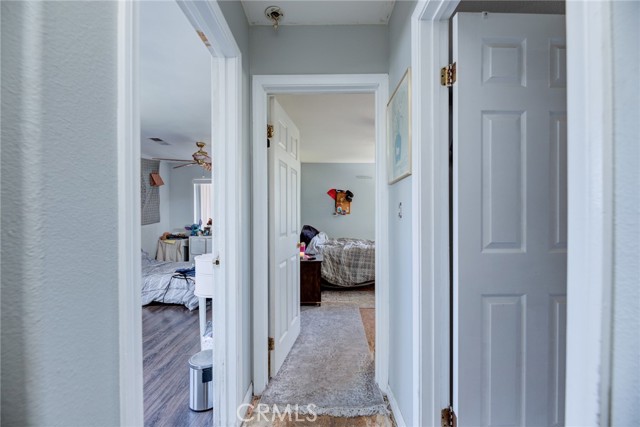 1025 Hallway with bedroom 1 on left bedroom 2 in front and bathroom on the right.