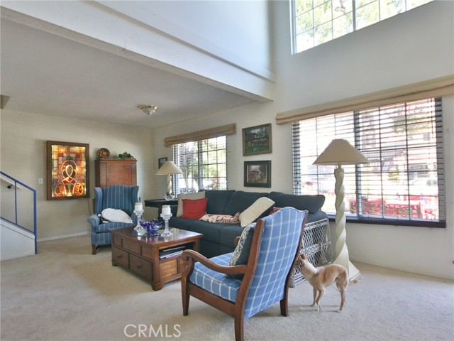 Front room with double story ceilings.  The stairs to the second level is on the left.  Nice windows overlooking the patio.