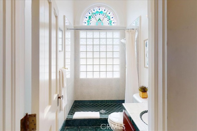 Downstairs bathroom with stained glass window.