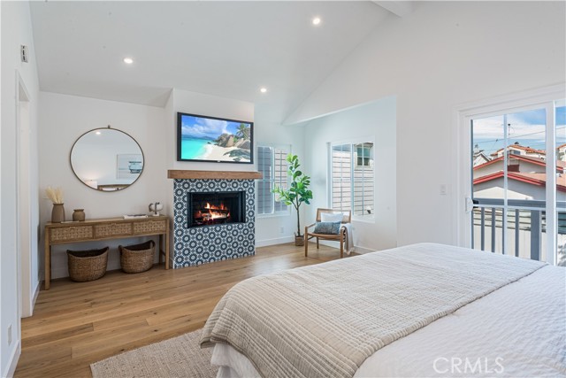 Primary bedroom with fireplace and private deck