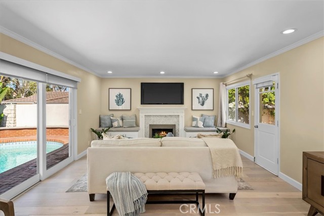 Light filled living Room with sliding door to pool and door to back yard