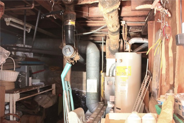 Utility Room/Cave.  Heater, Hot water heater and under the house pipes.