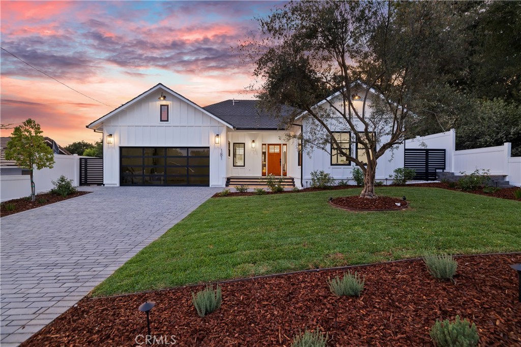 181 S Sunnyside Avenue Sierra Madre, California Crafted with the avid entertainer in mind, this stunning, newly constructed Sierra Madre residence is a true showstopper and will take your breath away at first impression! Set on a sizable lot, an impressive brick paver driveway welcomes you upon arrival. Manicured landscaping leads you to the front door with the area magnificently illuminated at night by an array of lighting. Come inside to discover a neutral-hued palette across an open layout that's further enlivened by natural sunlight coming in through a host of windows. Sleekly designed, the abode's modern farmhouse style delivers a remarkably crisp, contemporary look with light wide-plank floors flowing gracefully throughout. A fireplace lends warmth to a decidedly luxurious living room where visitors can bask in verdant vistas through black-trimmed windows. The home chef can serve fine fare from the nearby kitchen with stainless steel appliances, stylish pendant lighting, elegant white cabinetry, and a 4-seater waterfall island. Bespoke details abound with a gleaming backsplash, floating wooden shelving, and gold accents defining your culinary space. A beautifully ornate chandelier makes the dining area an ideal setting for enjoying meals any time of day. Once you're ready to call it a night, 4 all-white, generously sized bedrooms with wood-look floors, recessed lights, and ceiling fans are sure to wrap you in total serenity. Glass sliders in the primary suite frame scenic views of the yard. You can effortlessly admire the panoramas from your private retreat or head out for fresh air without ever venturing far from your quarters. Pamper yourself after a long day in the sumptuous ensuite, fitted with dual vanities, chic light fixtures, a walk-in shower, and stress-dissolving tub. One of the other bedrooms could be a dedicated home office, and your additional 2 baths equally showcase clean, refined touches. Living here, you’ll want to carve out time for leisure and relaxation with a sensational mulch-lined brick paver patio in your outdoor oasis. Whether you want to dine alfresco in multiple seating areas, play with the little ones, or catch up on your reading. As if that weren't enough, the immaculate home also features an attached 2-car garage and is conveniently situated near shops, restaurants, parks, and schools. Melding an exquisite design with comfort-inducing bedrooms, terrific spaces for entertaining, and a superb location, you will be instantly captivated by this gem.