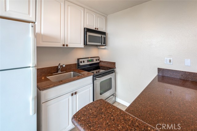 Gorgeous granite counter tops in this remodeled kitchen. (Refrigerator is included.)