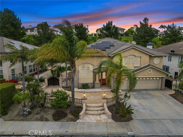 Located in the highly sought after Pointe East Lake community of Yorba Linda awaits your new home. This elegant 4 bedroom, 3.5 bathroom home is a spacious 3,938 sq. ft property, nestled in at the end of a cul-de-sac that showcases panoramic views that stretch as far as Catalina Island. A professionally hardscape front welcomes you with mature palm trees, enchanting fountain, and ample patio space to sit and enjoy the sunset. Upon entering you'll be greeted by the formal entry way with decorative inlayed stone floors. The formal living room boasts a two story ceiling and Palladian windows that let the natural light soak into the space.  Just off of the formal living room is the formal dinning with it's stunning tray ceiling and entrance to the kitchen. 
The chef inspired kitchen is a dream come true with granite countertops, cherry cabinets, center island with bar sink, 6 burner stove, and dual oven it is perfect for hosting dinner parties or the aspiring chef. The open concept flows into a dinning nook and family room with fireplace and built in shelving with plenty of storage. Down the hallway off of the entrance is a main floor bedroom with an en-suite 3/4 bath, an additional half bath, as well as a separate laundry room with entrance to the roomy 3 car garage. Make your way up the Mediterranean style staircase to find the primary suite, it's a luxurious space featuring a deep walk-in closet, quaint sitting area and a spa like bathroom with dual granite countertops, separate walk in shower and jetted soaking tub. Also located upstairs are 2 spacious bedrooms, a full bathroom, as well as a grand bonus room complete with fireplace, two built in desks and shelving as well as a stunning city view. This exquisite home is a marvel of modern technology, designed with the environment in mind. Powered by the sun, it features a cutting-edge Tesla solar energy system combined with Tesla backup batteries, providing an unrivaled level of energy independence and efficiency. Outside you will find an entertainer's backyard with built in BBQ, peaceful fountain, and fruit trees. Living in East Lake Village Community you will get the best of amenities such as a main, two-level clubhouse, 3 pools, spa, basketball courts, horse trails, tennis & sand volleyball courts, fitness facilities, trails, and so much more! Let's not forget you are just minutes away from award winning schools, shopping, dining, and recreational actives. Come see what gracious living is all about!