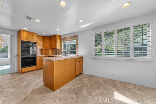 tile floors in kitchen  shutters and recessed lighting
Room for a kitchen table

r