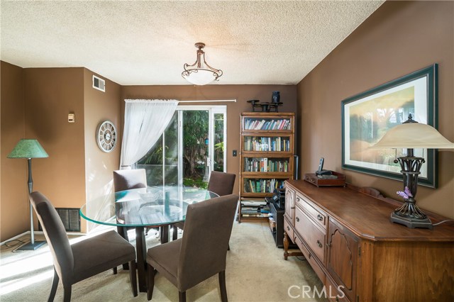 Dining area has sliding glass doors that leads to large, private backyard.