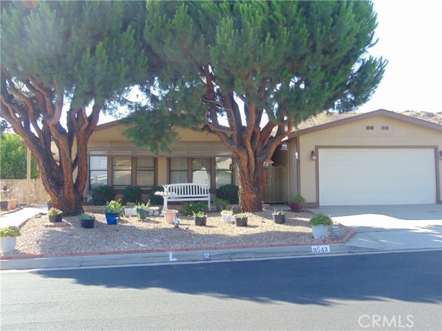 9543 Sharondale Road Calimesa, California Located in one of Calimesa's desirable senior 55+ community. You own the land. Curb appeal with park like settings, low maintenance front yard. This 3 bedroom home, 2 bath, has newer A/C and Hot water heater. Ceiling fans throughout. Laminate flooring except bathrooms have tile flooring. Open floor plan, two separate dining areas. Kitchen has pantry cupboard. Skylight for brightness. Stainless steel, 4 burner with longer griddle burner in middle of gas stove top. Free standing range. microwave and dishwasher. Side by side refrigerator included with easy access water and ice. Arch way entrance to open separate dinning room. Master bedroom is on opposite side of the home from the other two bedrooms. Master has large walk in closet, with mirrored doors, soaker/garden tub with separate shower. Guest bath has larger shower over tub. Bay windows in two guest bedrooms. Individual laundry room. washer and dryer included. Sliding glass door, handicap grab bars, entrance to Enclosed porch for added living area with bonus room attached for added storage. Fenced breezeway. Long covered front patio, enjoyment while watching the sunsets. Completely fenced back yard, Lemon tree. Two car garage with two work benches, plenty of room for storage. HOA amenities, salt water pool and spa, Banquet facilities, billiard table, ping pong table, exercise room, library, enjoyment of greenbelts through out the community. Metered water and sewer is included with the HOA.