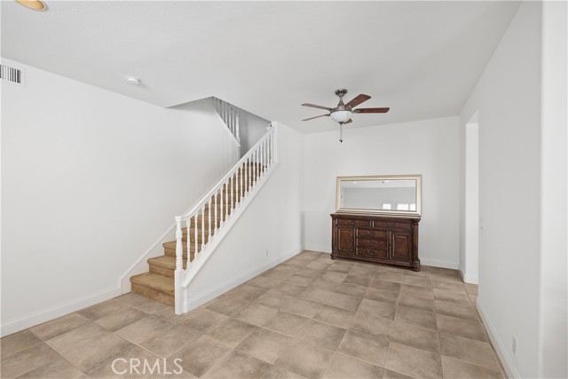 View from the living room area, looking into the dining room and stairs