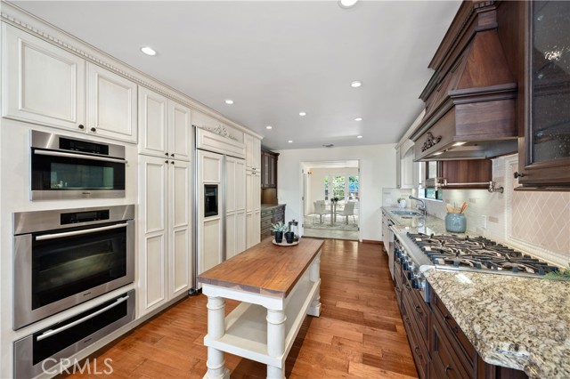 Miele ovens+warmer, Thermador 6 burner gas range, integrated GE Monogram fridge.