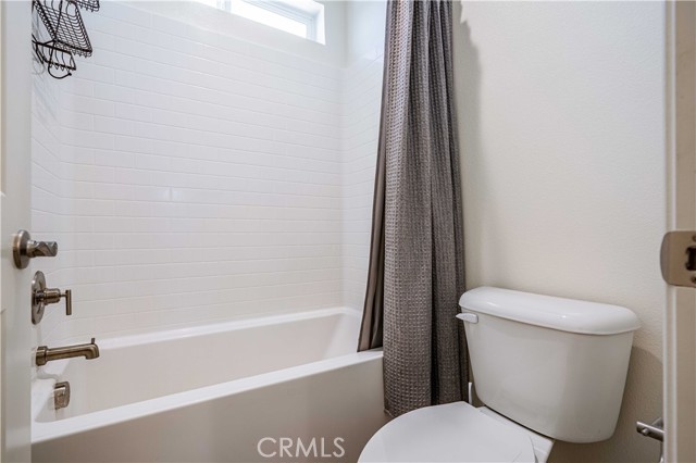 The third bathroom tub/shower with water closet