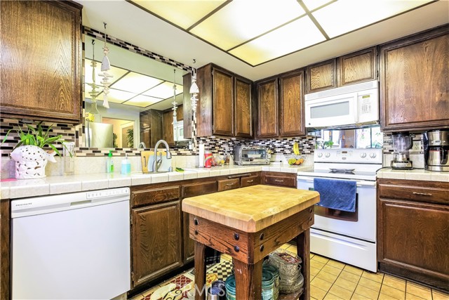 The Kitchen is Large and has Lots of Cabinets, Storage and Counter Space. The Kitchen has a large Pantry Cabinet and a Bar Counter next to the Dining Area