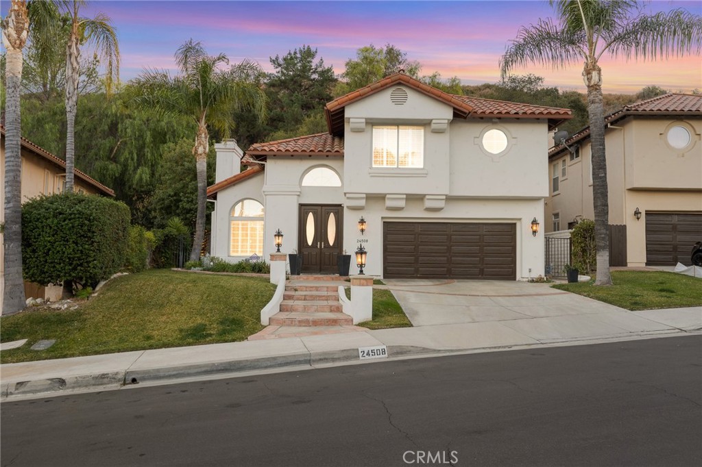 Welcome to 24508 Ebelden Ave in Newhall, CA, nestled in the heart of Hidden Valley in Newhall! This exquisite 2,923 sq. ft., 4-bedroom, 3-bathroom, 2-story home is a perfect blend of elegance, functionality, and comfort in a highly desirable neighborhood. As you enter, you’re greeted by a grand staircase, soaring ceilings, and an abundance of natural light that flows through the open-concept living and dining areas. The family room, complete with a cozy fireplace, opens seamlessly to the beautifully renovated kitchen, which features modern finishes, ample counter space, plenty of cabinetry, and a breakfast nook. The first level showcases stunning new marble flooring, adding a touch of luxury and sophistication. Upstairs, the luxurious primary suite offers a private retreat with a fully renovated, spa-like bathroom featuring dual vanities, a soaking tub, a separate shower, a bidet, and generous closet space. The additional bathrooms combine modern convenience with thoughtful design, and the secondary bedrooms are spacious and versatile, perfect for family, guests, or a home office. One of the upstairs bedrooms has been freshly painted, adding a fresh and inviting feel. A second fireplace adds warmth and character to the home. The outdoor space is an entertainer’s dream, boasting a beautifully landscaped backyard, a built-in BBQ area, and plenty of room for gatherings or relaxation. The exterior walls and patio cover have been recently painted, enhancing the home’s curb appeal and charm. Additional highlights include a 2-car garage, ample storage throughout, and access to community amenities, including a sparkling pool and well-maintained common areas. Conveniently located near top-rated schools, parks, hiking trails, shopping, dining, and easy freeway access, this home truly has it all. Don’t miss this rare opportunity to own a stunning property in the heart of Newhall!