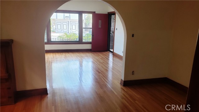 One of the front units dining room to Living room with gorgeoous hardwood floors - photo taken by the owners