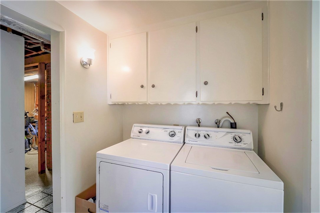 The laundry room is well sized with storage cabinets and can accommodate a full sized washer and dryer. The full bath is to the right and the door to the left leads to the huge bonus room.