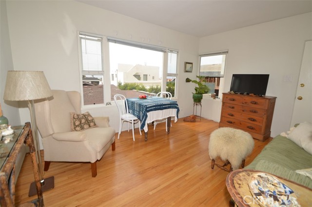 This is the wonderful living room of the one bedroom unit with no one above or below you! Take a look at these original refinished hardwood floors--beautiful