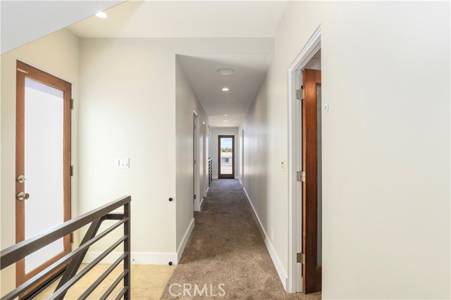 Hallway between bedrooms with direct access to the left to your rooftop deck!