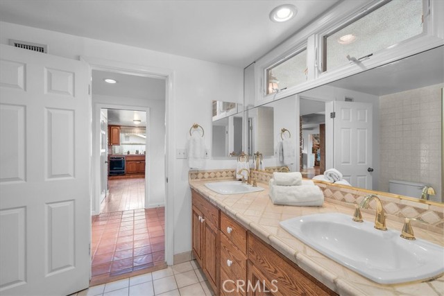 Primary Bathroom #1 with dual sinks and step in shower.