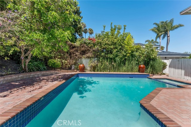 Refreshing pool with hot tub.