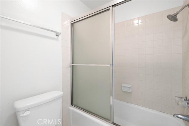 Hallway full bathroom with spacious vanity and counter space with separate room for tub/shower.