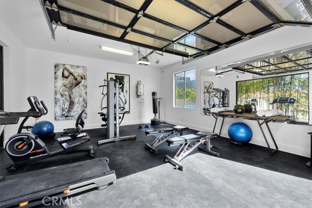 Second two car garage used as home gym opens to breeze way between home