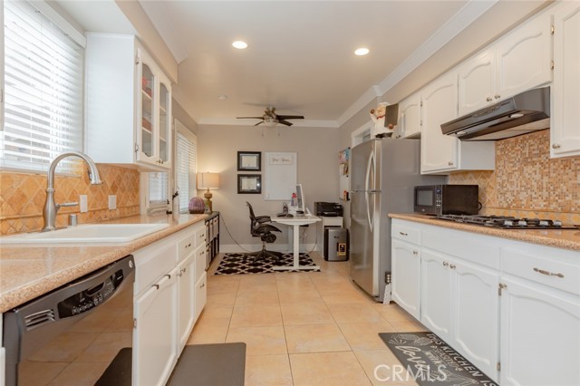 Kitchen with granite counters and breakfast nook currently being used as office space