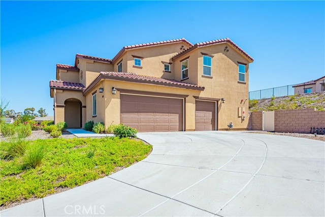 Long grand driveway is paved and leads to your side facing 3 1/2 car garage! Block wall and vynil fence trims the yard.