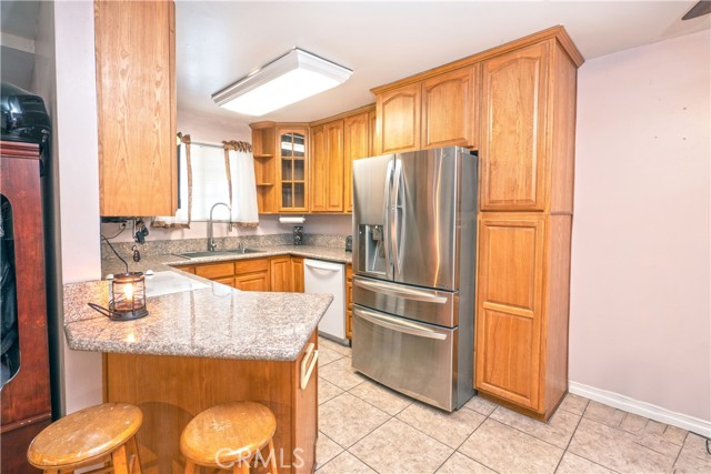 Kitchen has breakfast bar and granite counter tops