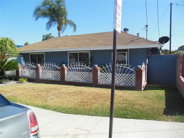 Main house with large gated drivway and garage.