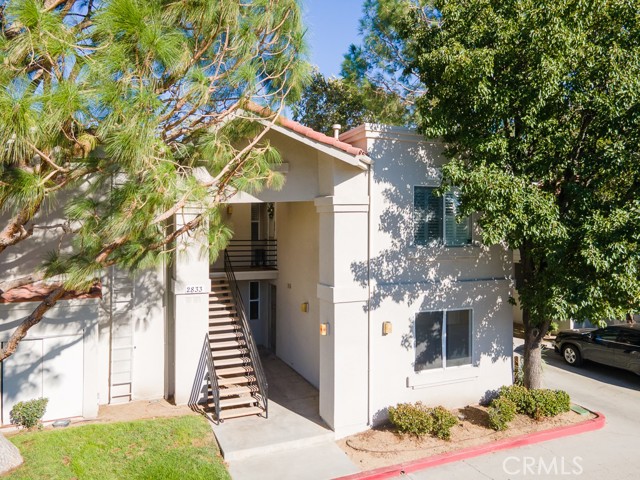 Lovely westside three-bedroom, two-bathroom end unit in beautiful Pine Creek Village! Great location at the end of the complex! What a great opportunity for a first time buyer or investor to hold.  Open functional floorplan with a spacious living room featuring a cozy fireplace and sliding door leading to an outdoor patio / balcony.  Kitchen features new stainless steel appliances and plenty of cabinet space for ample storage.  Other features throughout include tile floors, new carpet and new paint!  Two of the three bedrooms have direct access to their own bathroom! For added convenience laundry hookups available inside the unit. A large, two-car garage that has storage. HOA amenities include the following; a playground for kids to play, a pool to cool off in during the summer months, gym access, and tennis court to enjoy. Prime westside location near shopping, dining, and recreation.