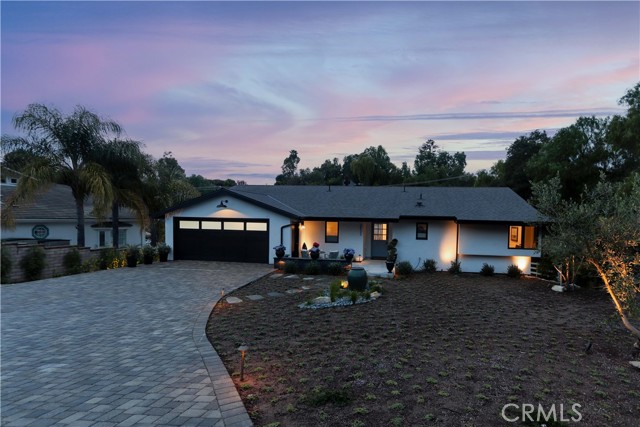 Soft, evening landscape lighting accents the ambiance of the outdoor space.