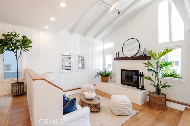 Sunny Living Room with Vaulted, Wood-Beamed Ceiling