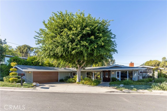 A classic mid-century ranch home, this will capture you as you wind down the tree-lined Spinning Wheel Lane in Rolling Hills Estates.