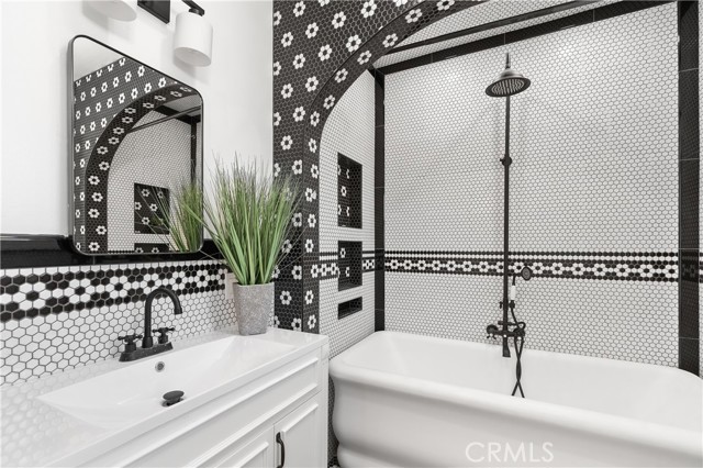 This bathroom is amazing, with an intricate floral tile pattern repeated throughout.