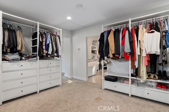 This primary walk in closet is the size of a small bedroom!