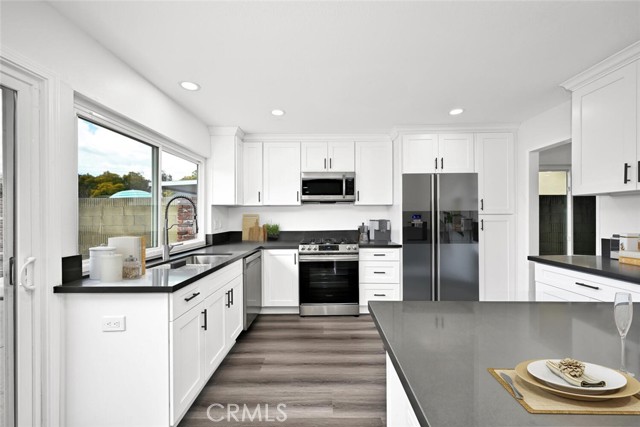 Kitchen also features recessed lights, vinyl plank flooring and stainless appliances. (virtually staged)
