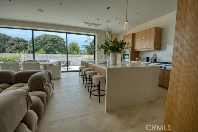 Kitchen dining seat up to 6 Counter custom cabinets with Fischer and Paykel luxury chefs kitchen 46 inch hood over the 6 burner stove with flat top and wok burner