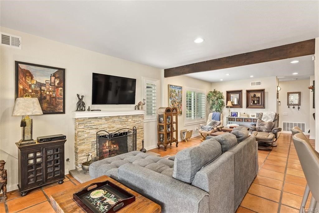 Family room is open to kitchen with fireplace and French doors to backyard oasis.