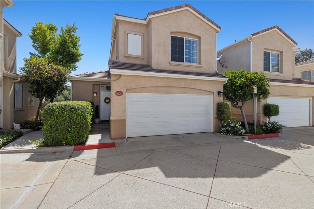 Discover this stunning, move-in ready home located in one of Valencia’s most desirable neighborhoods! Perfectly situated in a prime location, this detached townhome offers breathtaking panoramic views, a spacious and serene patio, and a direct-access two-car garage complete with a laundry area and ample storage. The thoughtful open-concept floor plan features a remodeled kitchen with cherry wood cabinetry, granite countertops, stainless steel appliances, and recessed lighting. Elegant porcelain tile floors enhance the downstairs living areas, while new wood laminate floors add warmth and style to the stairway and entire second floor. Vaulted ceilings and a cozy fireplace make the living space both inviting and ideal for entertaining. This highly sought-after dual master suite model includes two generously sized bedrooms, each with its own full en suite bathroom. Both bedrooms are light and bright with neutral designer paint tones, providing a relaxing, model-perfect atmosphere. Enjoy access to fantastic HOA amenities including two sparkling pools, a spa, half basketball court, green space, and a recreation center. All of this comes with a low HOA and no Mello-Roos! Ideally located within walking distance to scenic bike paths, trails, schools, dining, shopping, and with quick access to the freeway—this home offers the best of Valencia living!